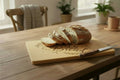 A rectangular bamboo cutting board with rounded corners, featuring the engraved text 'GIVE US THIS DAY Our Daily Bread' in dark brown lettering, flanked by wheat stalk illustrations. The board is shown resting on a wooden shelf against a plain light background.